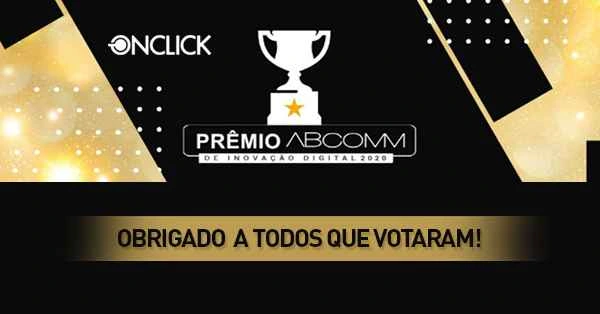 Banner preto e dourado comemorando a vitória da ONCLICK no "PRÊMIO ABCOMM DE INOVAÇÃO DIGITAL 2020". Imagem de um troféu no centro, com o logo da ONCLICK no topo e mensagem de agradecimento "OBRIGADO A TODOS QUE VOTARAM!" na parte inferior. O design luxuoso com efeitos brilhantes destaca a conquista da empresa em reconhecimento de excelência em inovação digital no setor de comércio eletrônico.